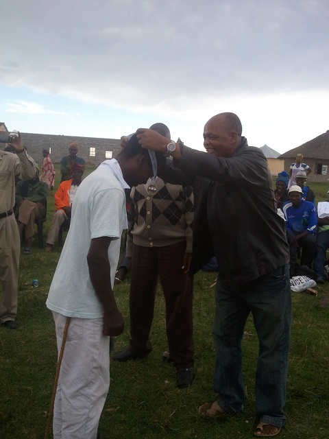 The Tshezi Team Leader accepts his medals